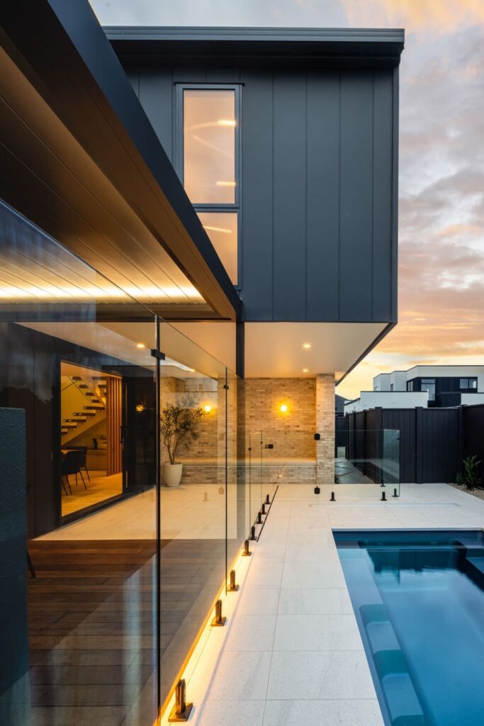 Dark-clad home with pool at dusk
